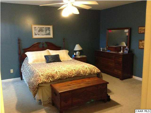 1030 Amber Ridge Road Charlottesville, VA 22901 - Photo 15 of 22 a bedroom with a bed and a mirror