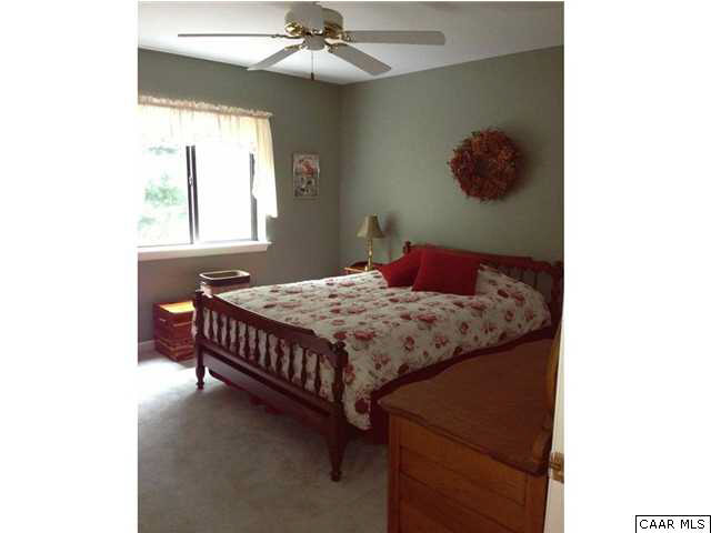 1030 Amber Ridge Road Charlottesville, VA 22901 - Photo 18 of 22 a bedroom with a bed and a chandelier