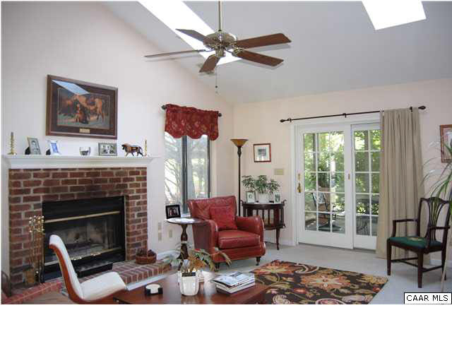 1030 Amber Ridge Road Charlottesville, VA 22901 - Photo 3 of 22 a living room with furniture a flat screen tv and a fireplace