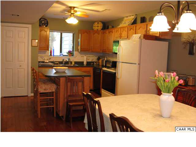 1030 Amber Ridge Road Charlottesville, VA 22901 - Photo 6 of 22 a kitchen with a table chairs and refrigerator