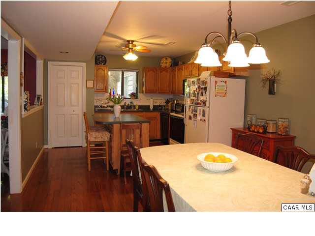 1030 Amber Ridge Road Charlottesville, VA 22901 - Photo 10 of 22 a kitchen that has a table chairs and refrigerator