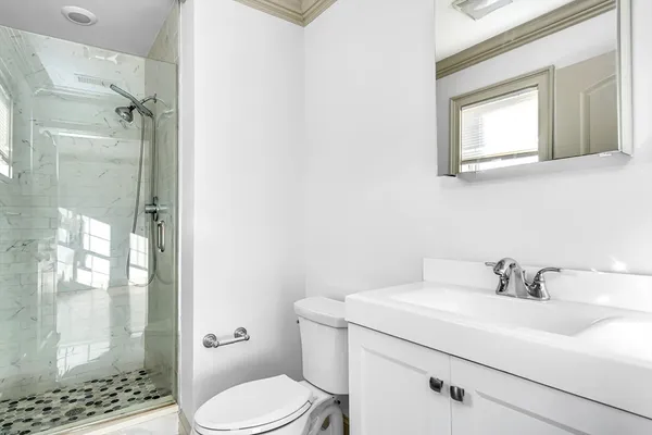 a bathroom with a sink toilet and shower