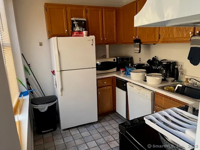 a kitchen with a refrigerator and a sink