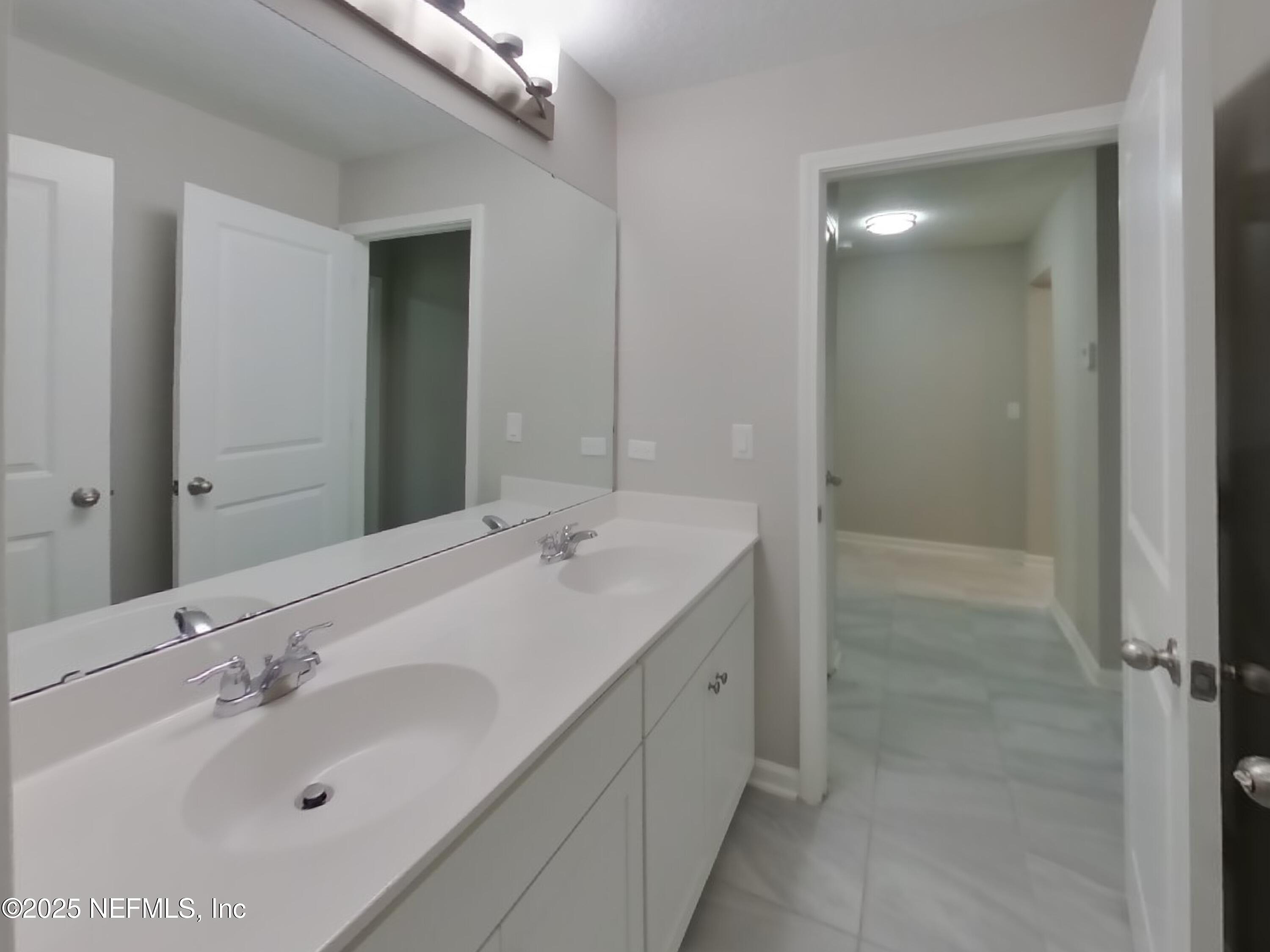 4889 Morning Rise Circle Jacksonville, FL 32218 - Photo 11 of 15 a bathroom with a sink and a mirror