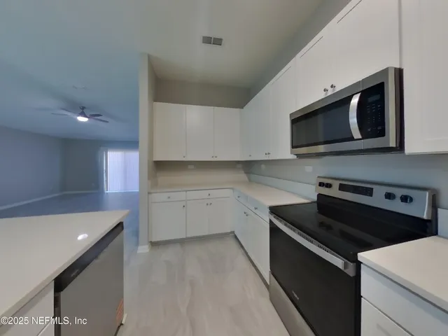 a kitchen with a stove microwave and sink