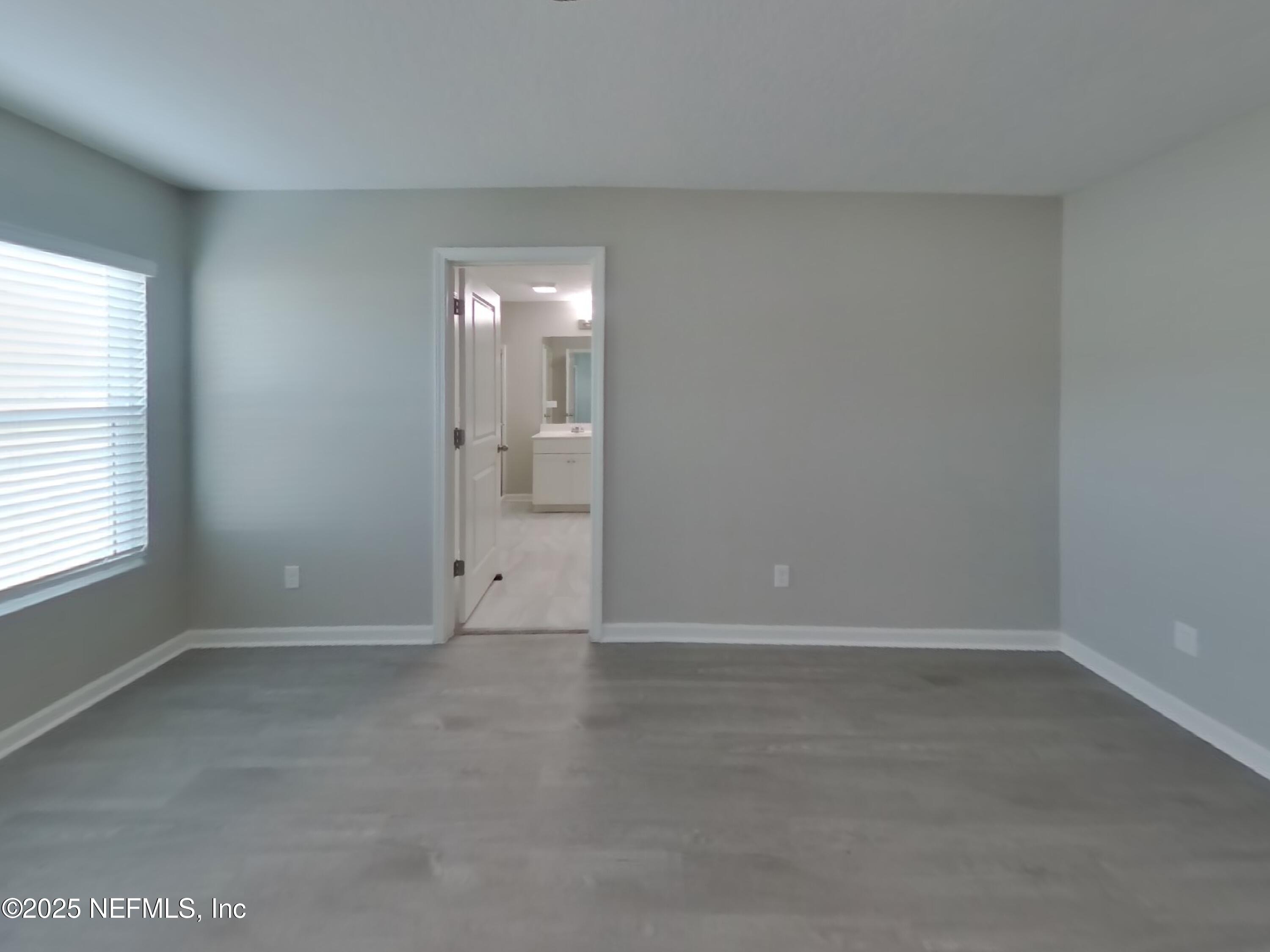 4889 Morning Rise Circle Jacksonville, FL 32218 - Photo 6 of 15 an empty room with windows and closet