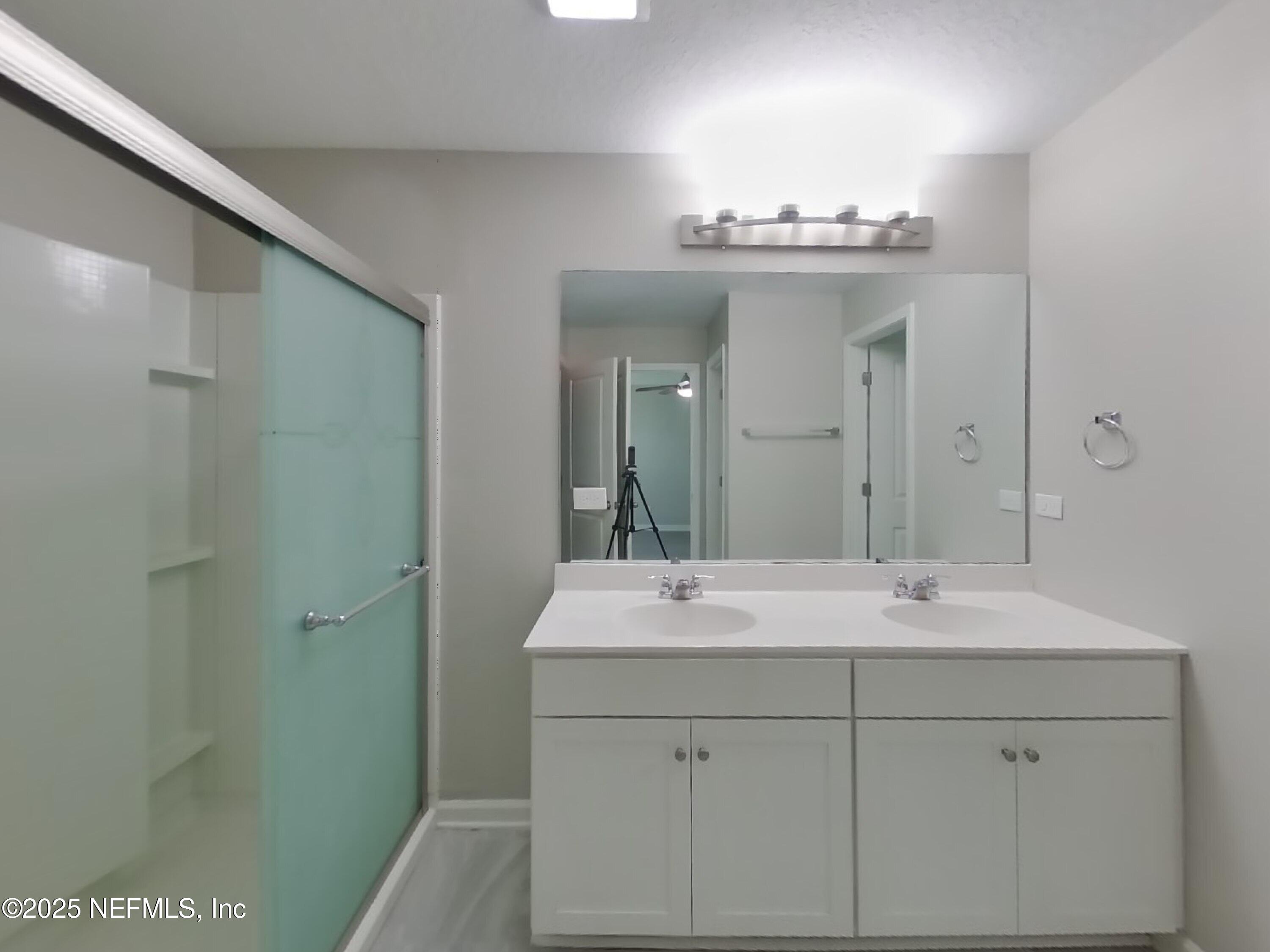 4889 Morning Rise Circle Jacksonville, FL 32218 - Photo 7 of 15 a bathroom with a sink and a mirror
