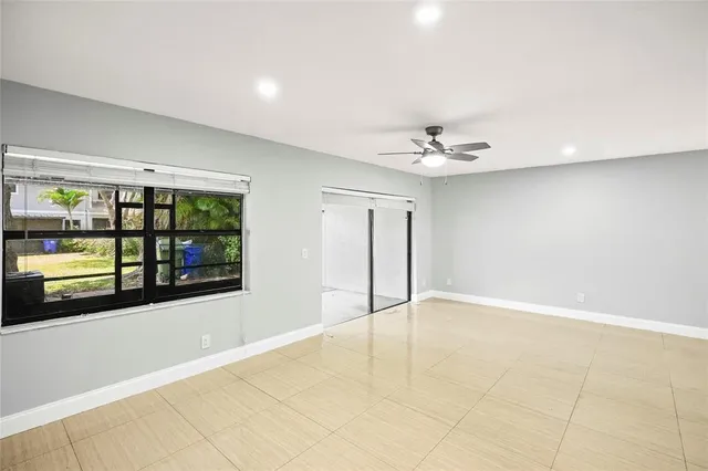 a view of a livingroom with a ceiling fan and window