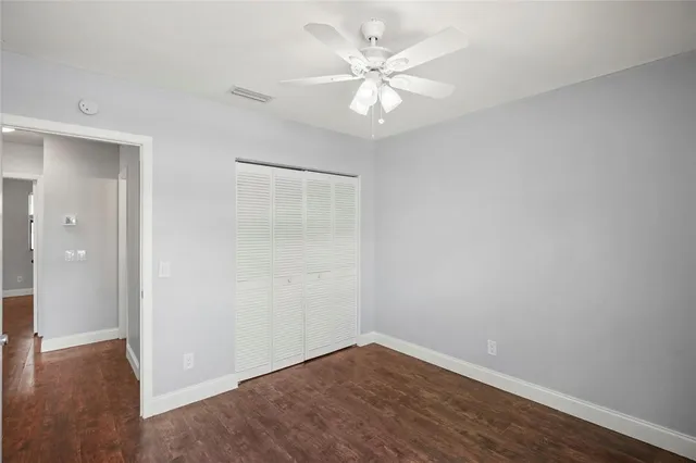 a view of an empty room with wooden floor