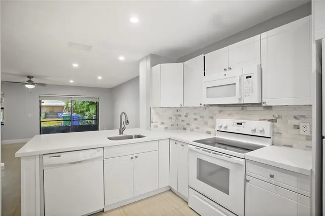 a kitchen with a sink stove and cabinets