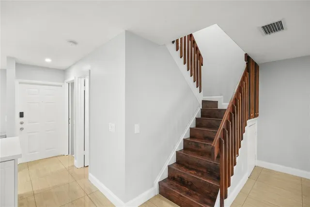 a view of entryway and gallery with wooden floor