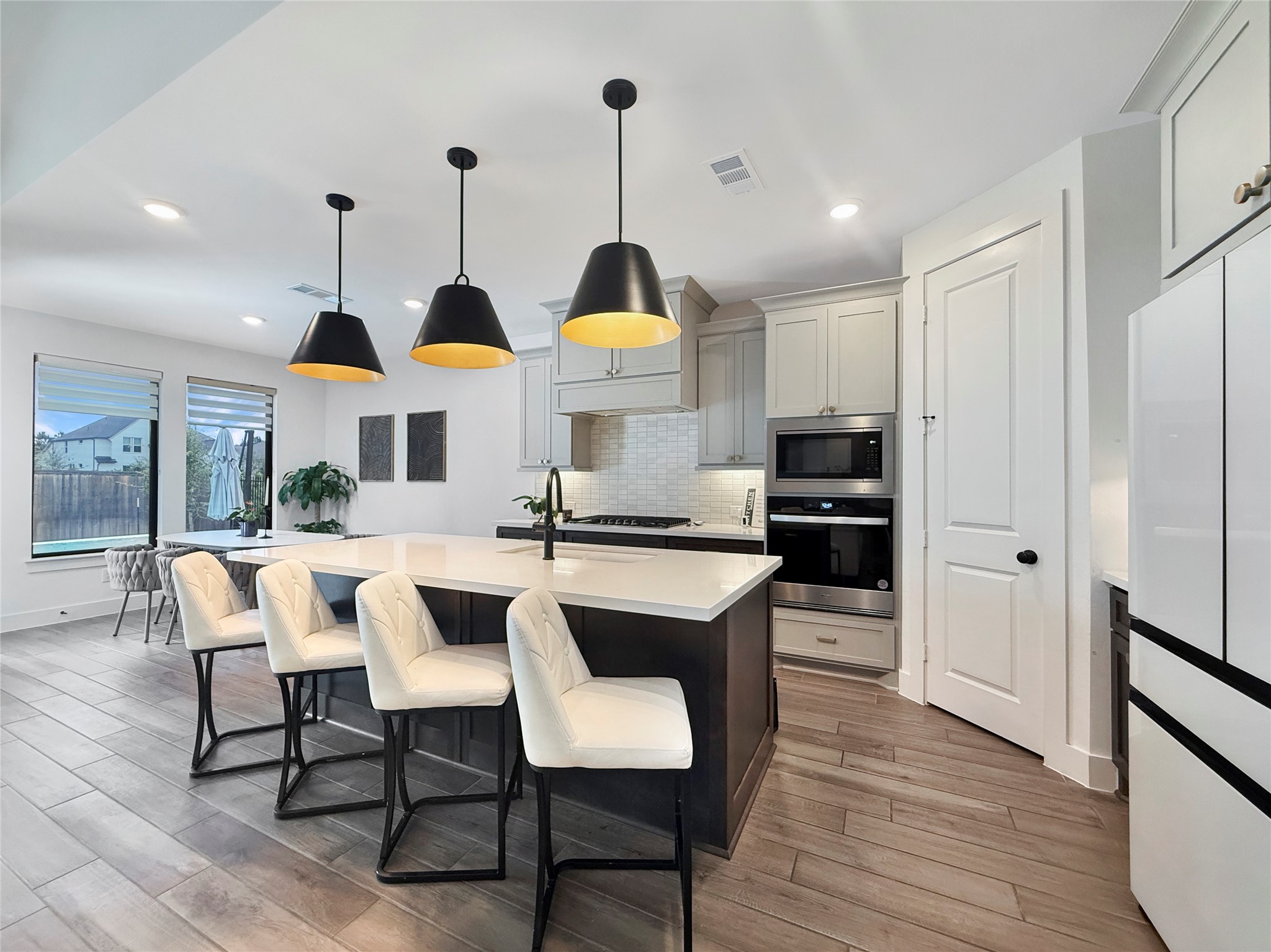 26918 Swanborough Road Spring, TX 77389 - Photo 12 of 50 A beautifully painted black island creates a sophisticated contrast against the gray kitchen, bringing depth, character, and a tailored design element to the heart of the home.