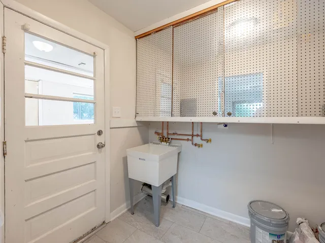 a bathroom with a sink a toilet and a window