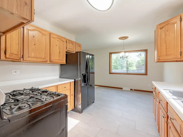 a kitchen with stainless steel appliances stove top oven and refrigerator