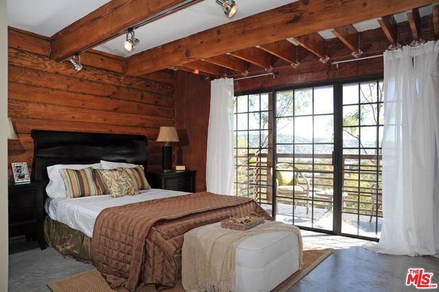 a bedroom with a large bed and a large window