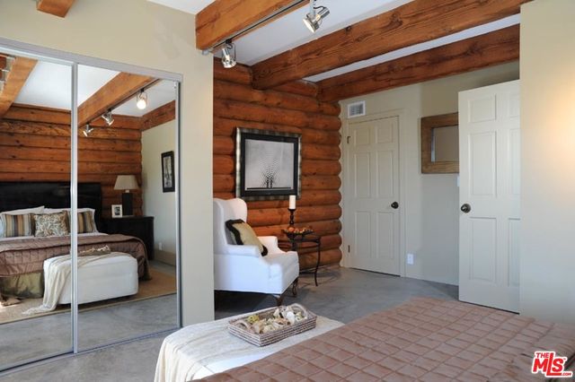 a bedroom with furniture and a wooden floor