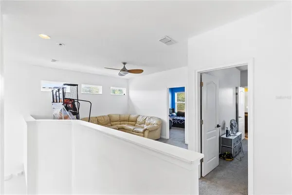 a living room with furniture and a large mirror