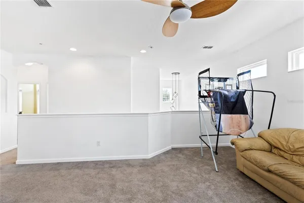 a view of a livingroom with furniture and a ceiling fan