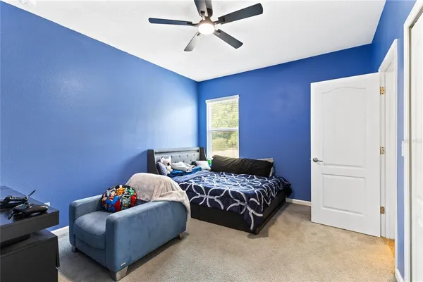 a bedroom with bed and window