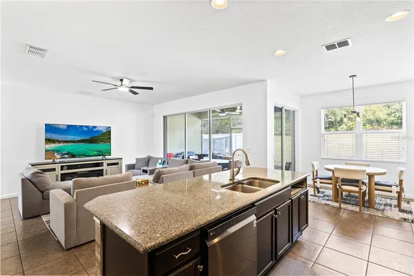 a kitchen with granite countertop a sink and a stove