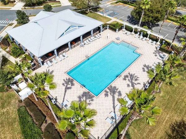 an aerial view of a house with a yard and trees