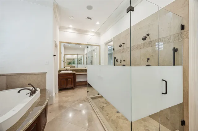 a large bathroom with a tub sink and mirror