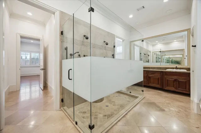 a large white bathroom with a sink a mirror and a shower