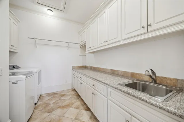a kitchen with white cabinets and a sink
