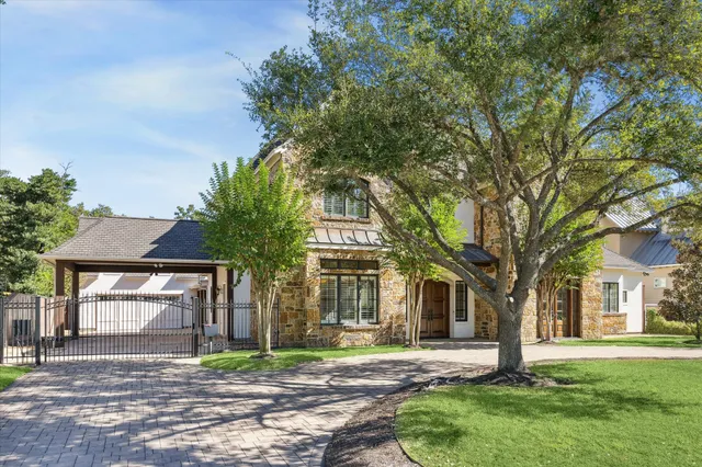 a house that has a tree in front of a house