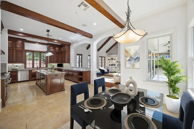 a dining room with furniture and a chandelier