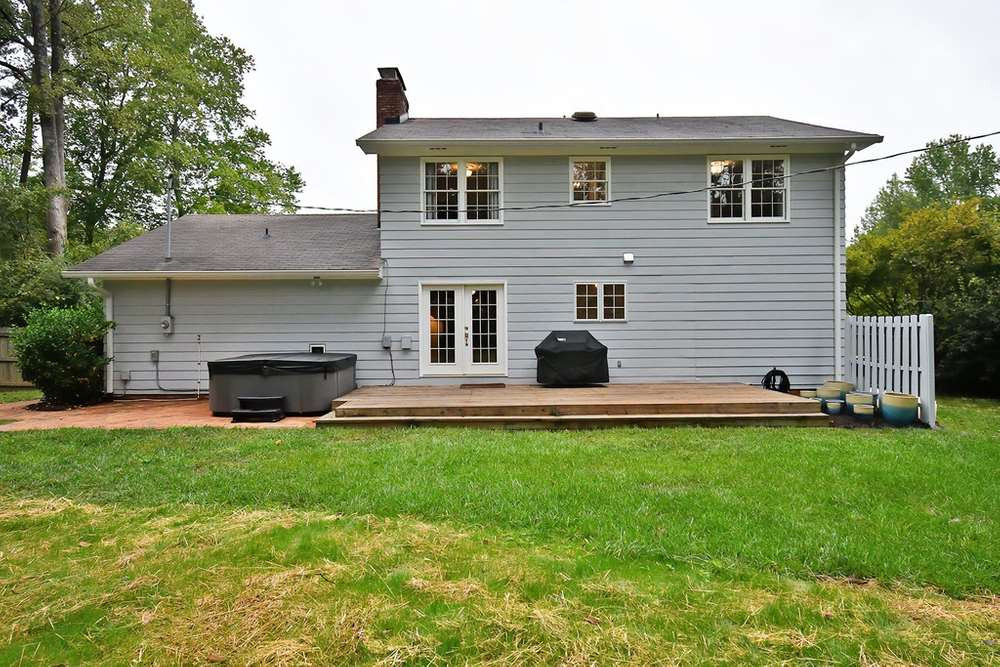 6405 Wrenwood Avenue Raleigh, NC 27607 - Photo 22 of 30 Large wooden back deck and brick patio make a great entertaining space. Exterior Back