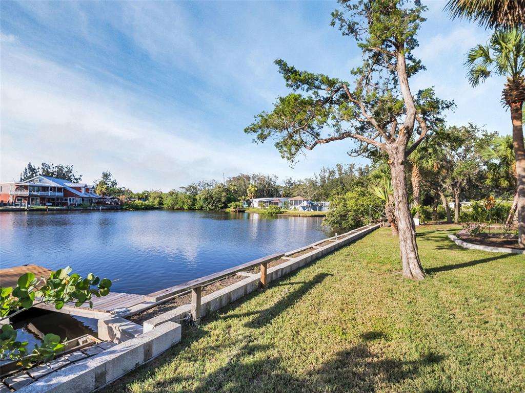 4915 S Road New Port Richey, FL 34652 - Photo 2 of 12 a view of a lake with a house in the background