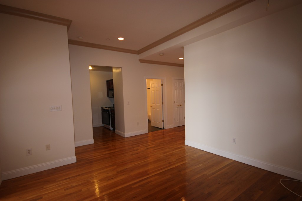 a view of wooden floor and a in closet