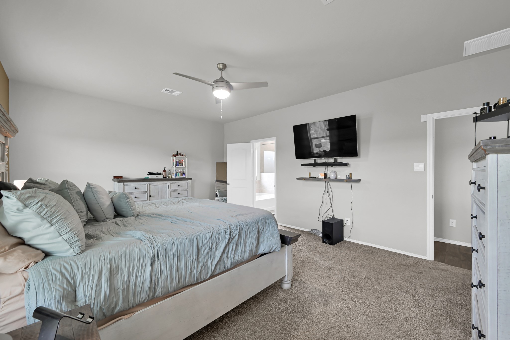 6302 Hendricks Harbor Conroe, TX 77304 - Photo 12 of 24 a bedroom with a bed tv and a window