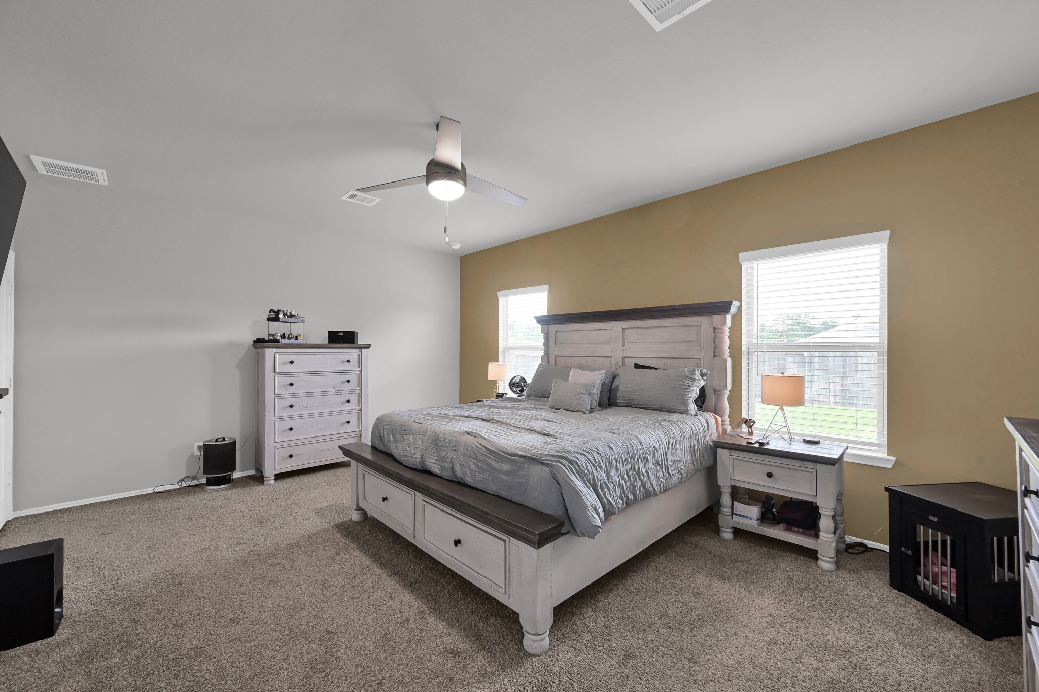 6302 Hendricks Harbor Conroe, TX 77304 - Photo 13 of 24 a spacious bedroom with a bed and a chandelier
