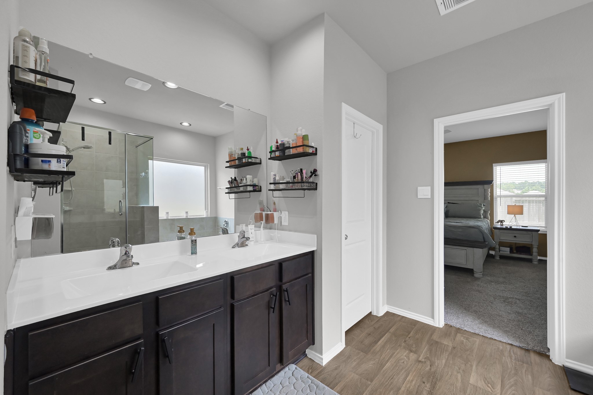 6302 Hendricks Harbor Conroe, TX 77304 - Photo 14 of 24 a en suite bathroom with a double vanity sink and a mirror