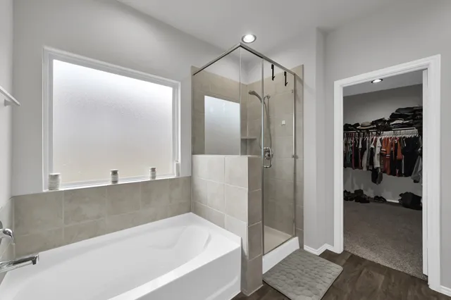 a bathroom with a bathtub and a shower