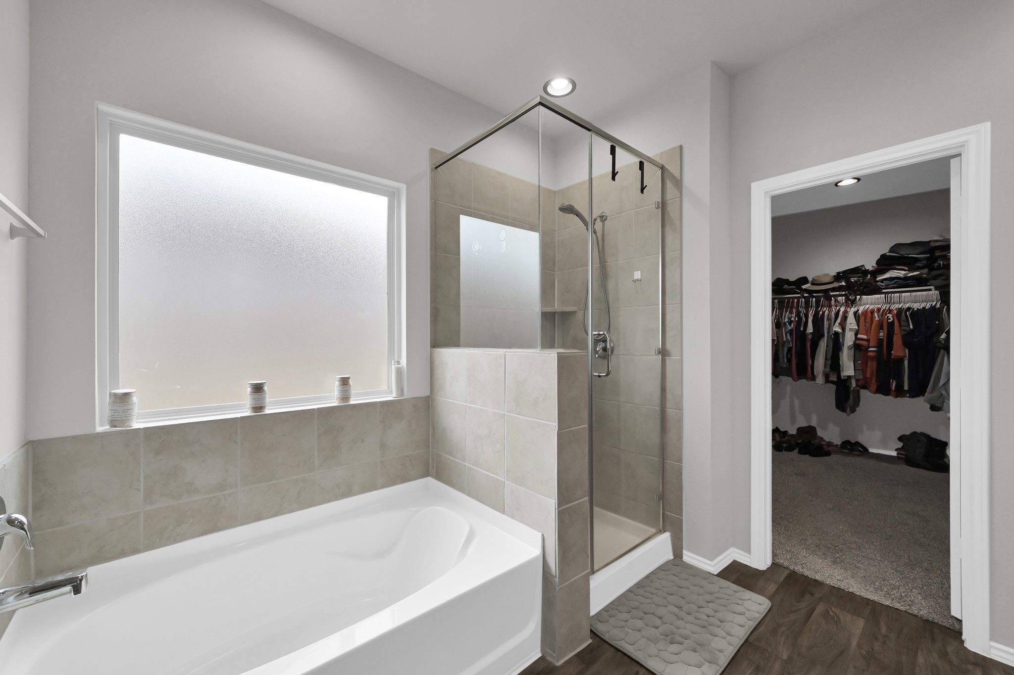 6302 Hendricks Harbor Conroe, TX 77304 - Photo 15 of 24 a bathroom with a bathtub and a shower