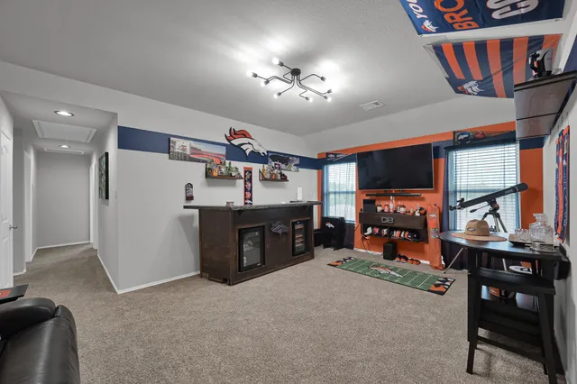 a view of a workspace with furniture and a flat screen tv