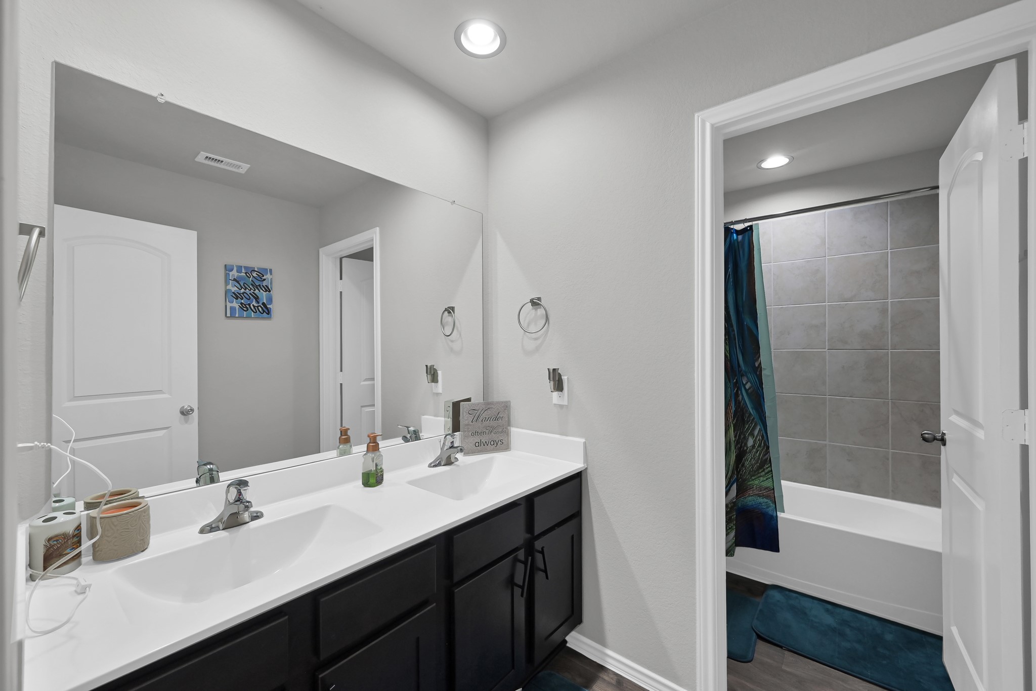 6302 Hendricks Harbor Conroe, TX 77304 - Photo 17 of 24 a bathroom with a double vanity sink mirror double and bathtub