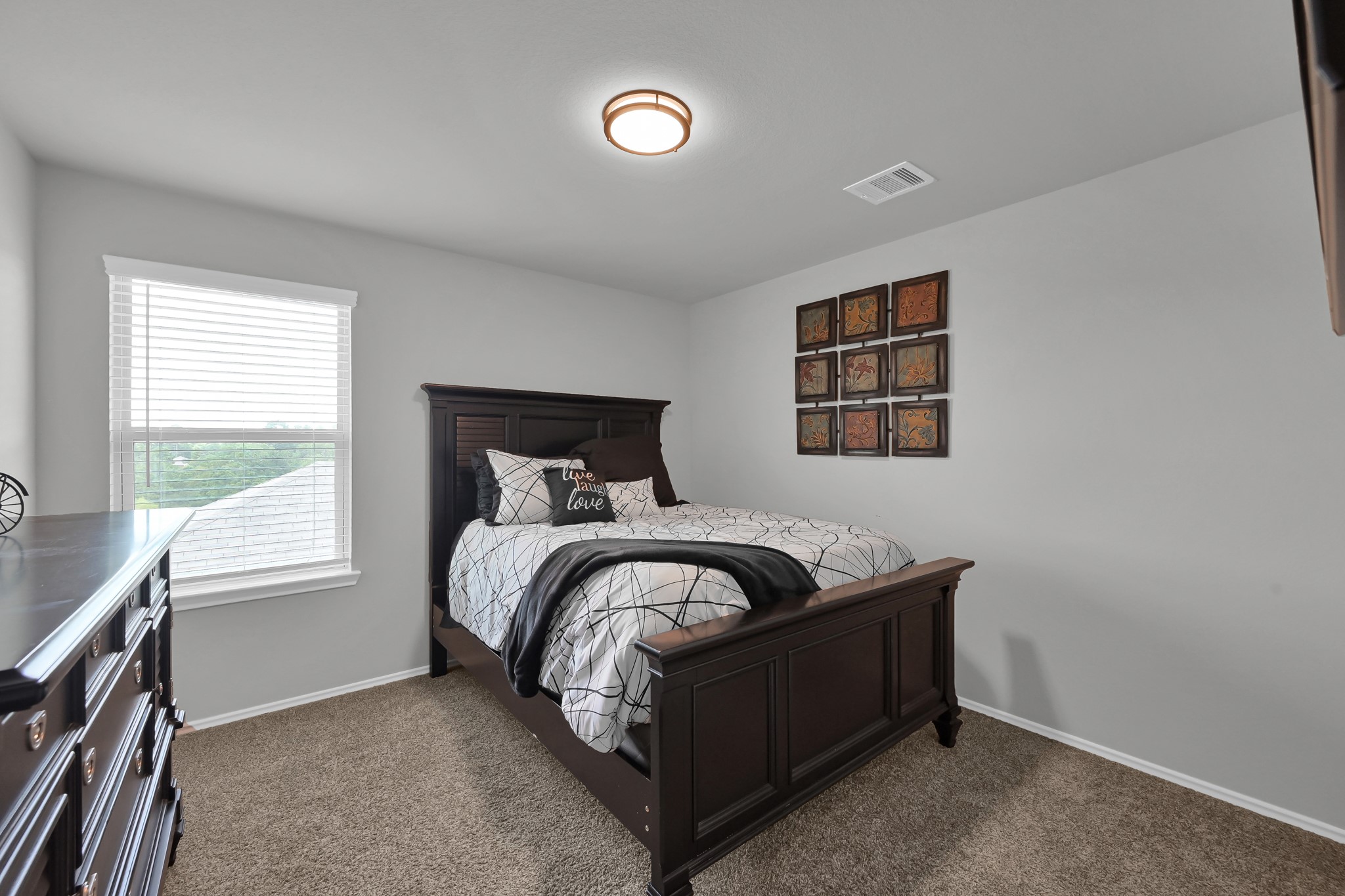6302 Hendricks Harbor Conroe, TX 77304 - Photo 19 of 24 a bedroom with a bed and a window
