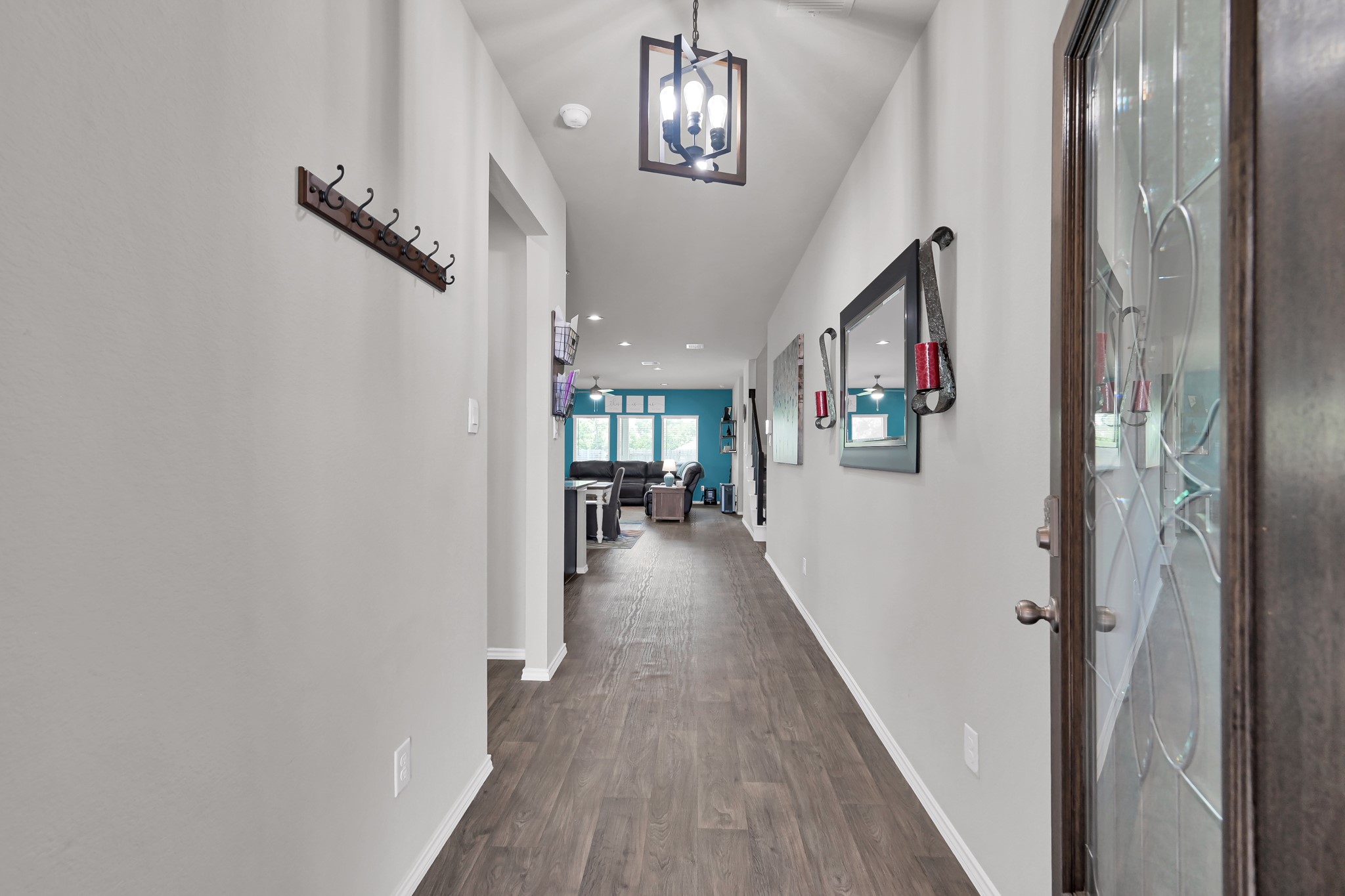 6302 Hendricks Harbor Conroe, TX 77304 - Photo 2 of 24 a view of a hallway with furniture and wooden floor