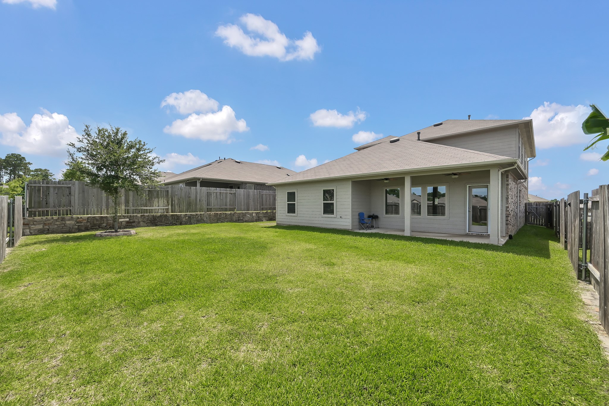 6302 Hendricks Harbor Conroe, TX 77304 - Photo 24 of 24 a front view of a house with a garden