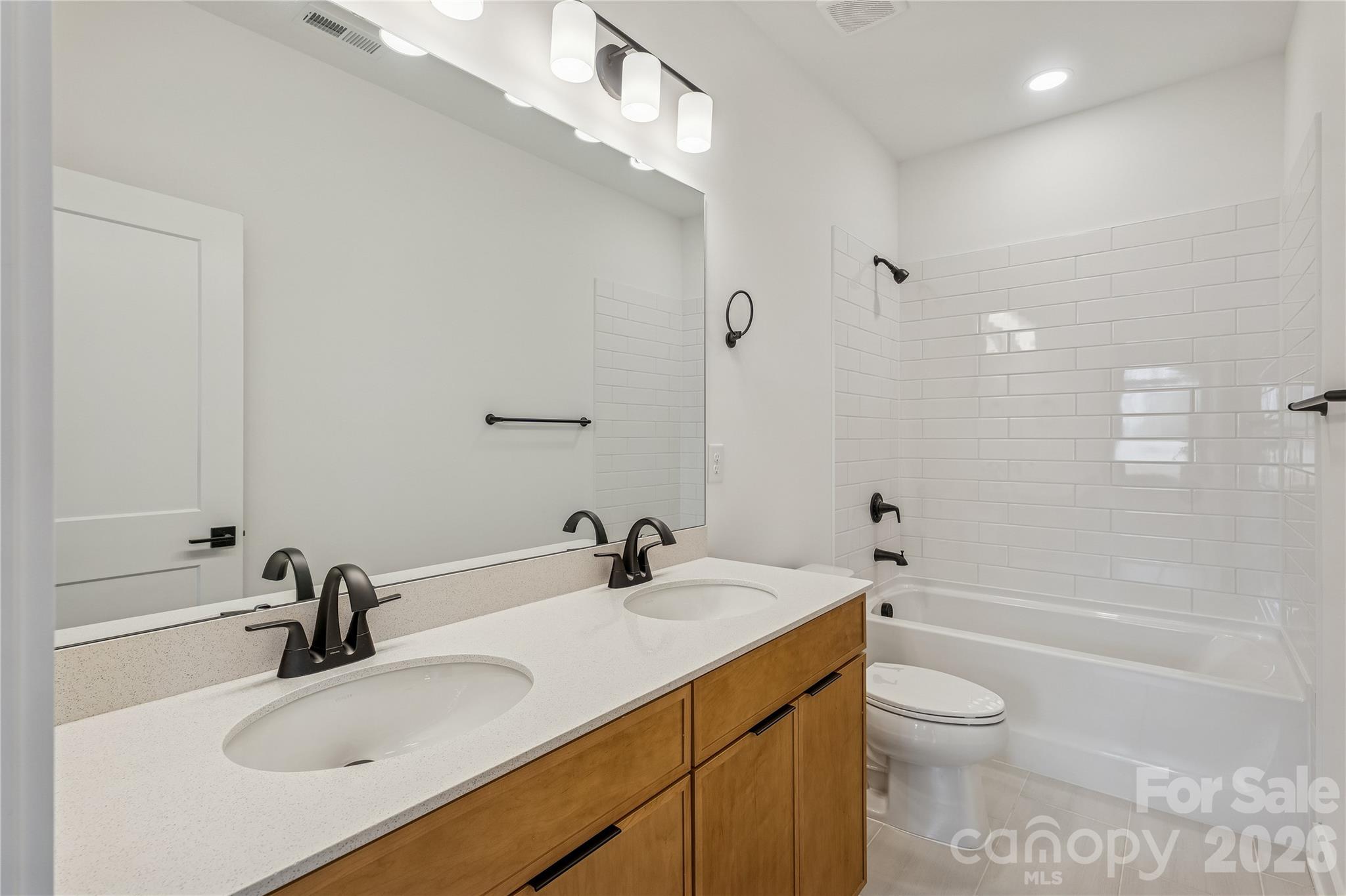 3024 Griffs Pond Road, Unit 388 Charlotte, NC 28269 - Photo 17 of 21 a bathroom with a sink a toilet and shower