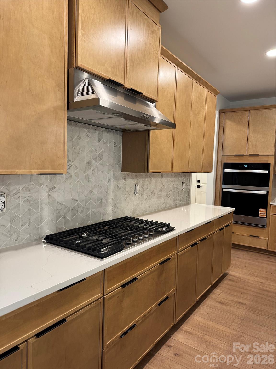 3024 Griffs Pond Road, Unit 388 Charlotte, NC 28269 - Photo 3 of 12 a kitchen with stainless steel appliances a stove a microwave and cabinets