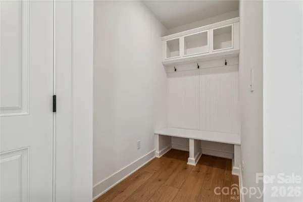 a view of an empty room with wooden floor