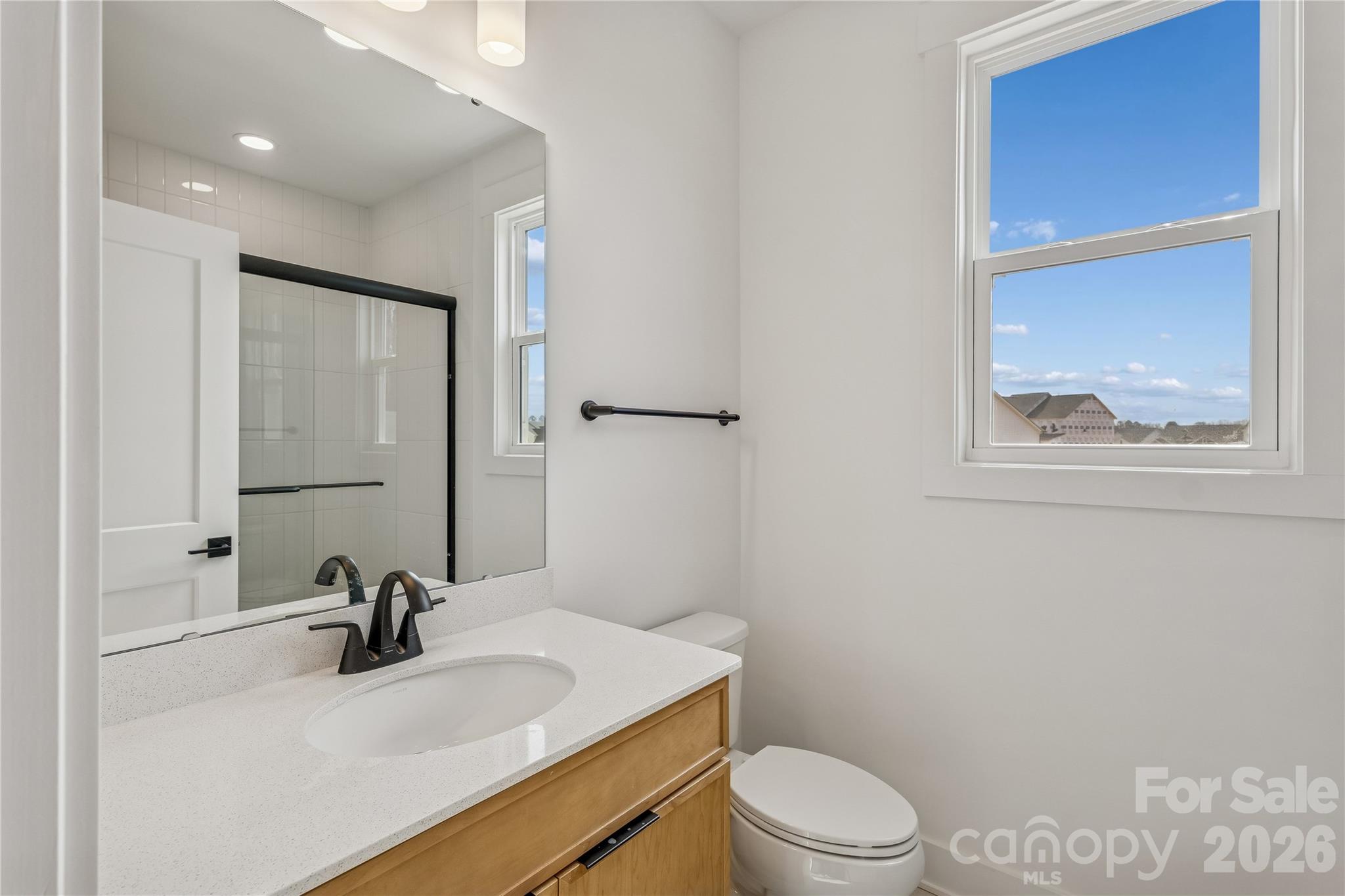 3024 Griffs Pond Road, Unit 388 Charlotte, NC 28269 - Photo 8 of 21 a bathroom with a sink vanity mirror and toilet