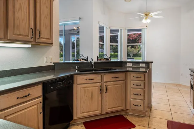 a kitchen with granite countertop a sink and cabinets