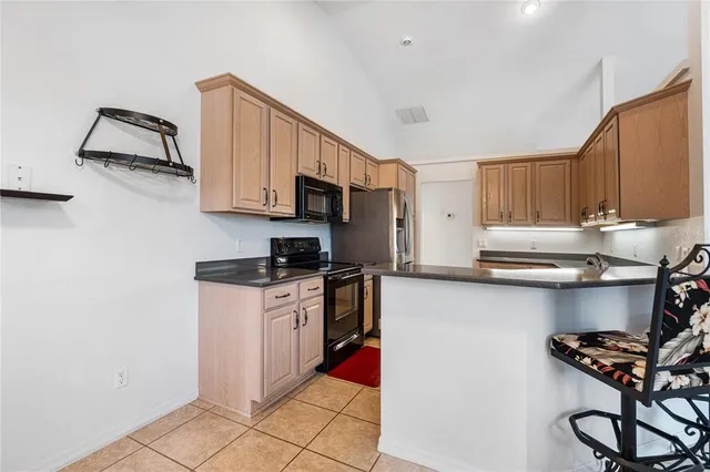 a kitchen with stainless steel appliances granite countertop a stove top oven a sink and dishwasher