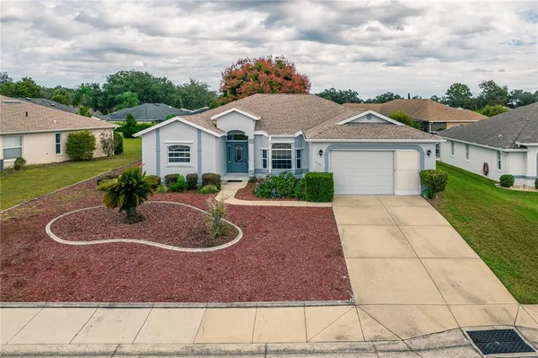 an aerial view of a house with a garden and pool